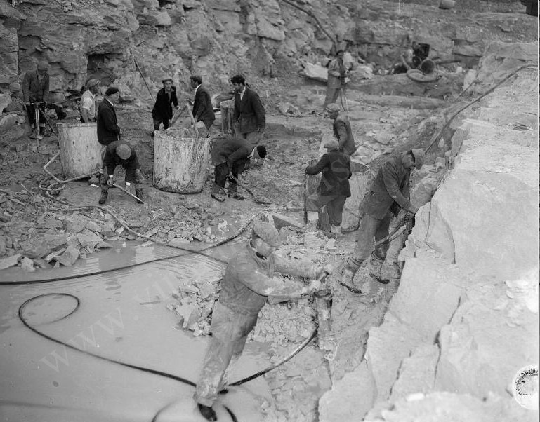 Workers digging into the rock below where the reactor would be